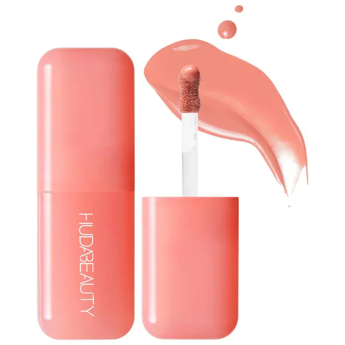 Blush liquide Huda Beauty en flacon transparent, teinte rose pêche avec embout applicateur
